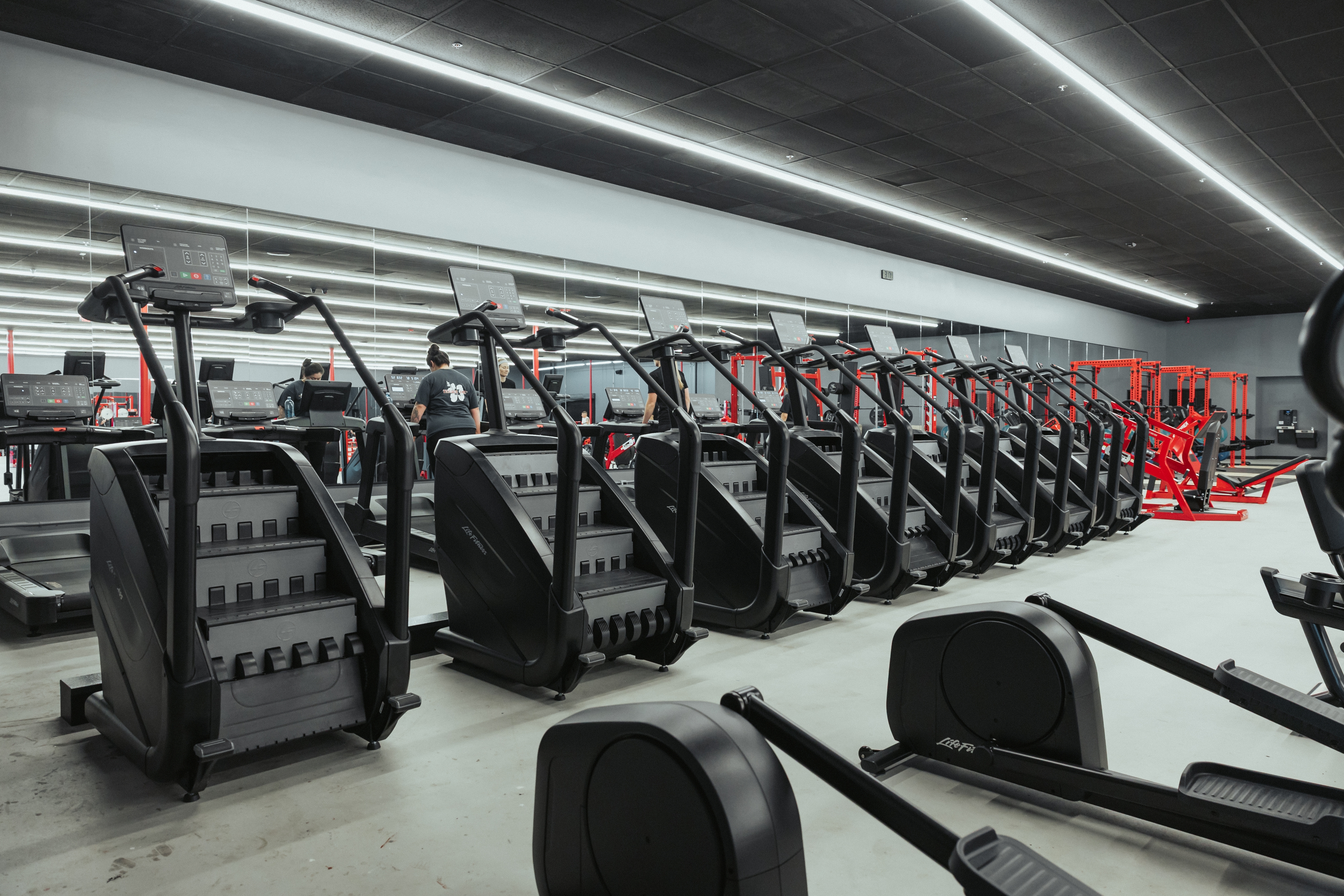 The Camarillo cardio deck — stair climbers and treadmills in a row with red racks behind