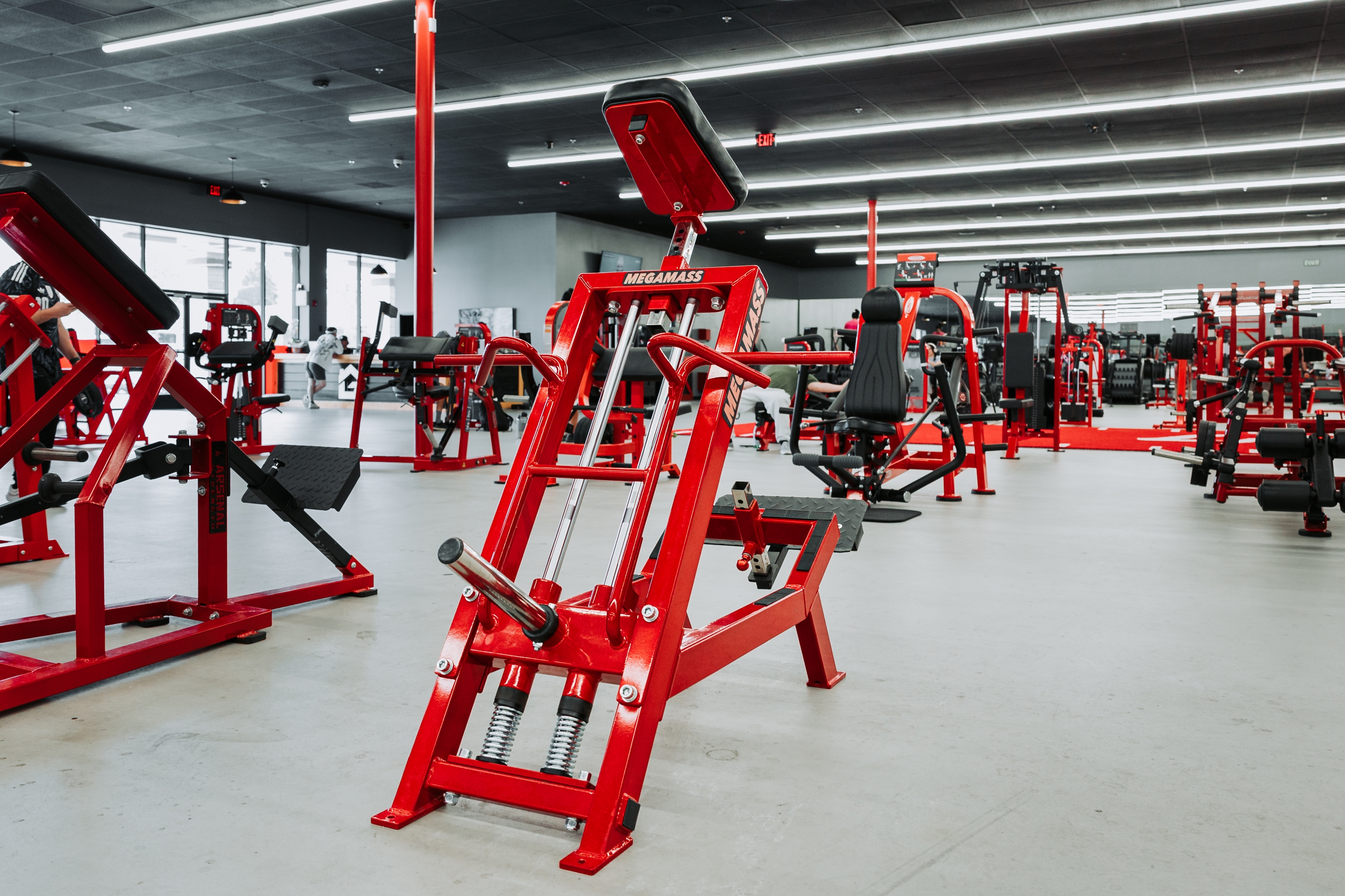 The Camarillo main floor — plate-loaded machines and red racks running down the room